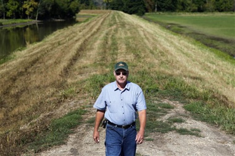 Geoff Sterne walks atop a levee protecting his farmland from the Mississippi River near Annada, Mo., on Thursday. Sterne's land is in an area effected by the so-called "Plan H" to tame the upper Mississippi.